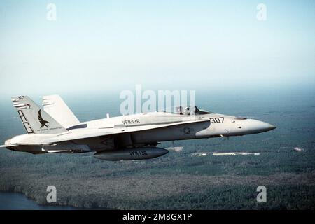 An air-to-air right side view of a Strike Fighter Squadron 136 (VFA-136) F/A-18C Hornet aircraft near Naval Station, Roosevelt Roads. State: Puerto Rico (PR) Country: United States Of America (USA) Stock Photo