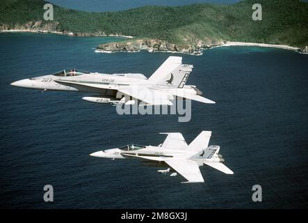 An air-to-air left side view of Strike Fighter Squadron 136 (VFA-136) F/A-18C Hornet aircraft near Naval Station, Roosevelt Roads. State: Puerto Rico (PR) Country: United States Of America (USA) Stock Photo