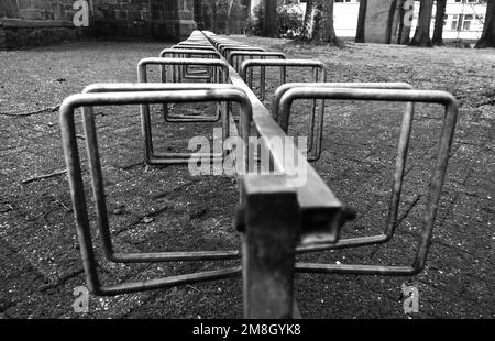 Row of bicycle stands at a church in black and white. Location: Emlichheim, Germany Stock Photo