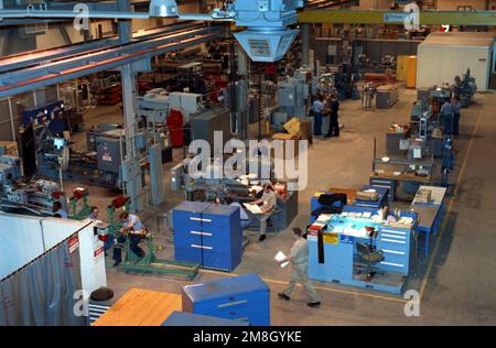 Overhead view of personnel at work in the machine shop of the Ships Intermediate Maintenance Facility. Base: Naval Station, New York State: New York (NY) Country: United States Of America (USA) Stock Photo