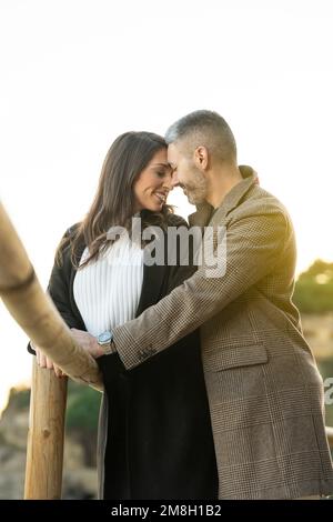 Romantic scene with a heterosexual couple looking each other and taking a walk Stock Photo