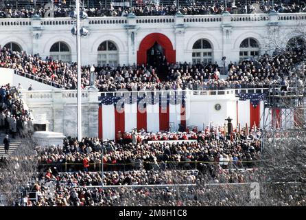 Armed Forces Inaugural Committee behind the scenes. Crowds stand near the capitol during the swearing-in ceremony. Country: Unknown Stock Photo