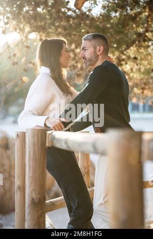Romantic scene with a heterosexual couple looking each other  Stock Photo