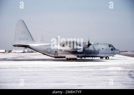 A right side view of a Marine Refueler-Transport Squadron 253 (VMGRT-253) KC-130F Hercules aircraft parked on a snow-covered flight line. Base: Andrews Air Force Base State: Maryland (MD) Country: United States Of America (USA) Stock Photo