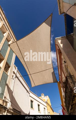 facade of old buildings in the old town of Faro, Portugal, Algarve in panoramic view with sun shadow Stock Photo