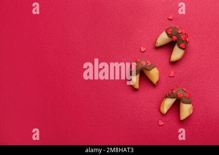 Fortune cookies with hearts on red background. Valentine's Day celebration Stock Photo
