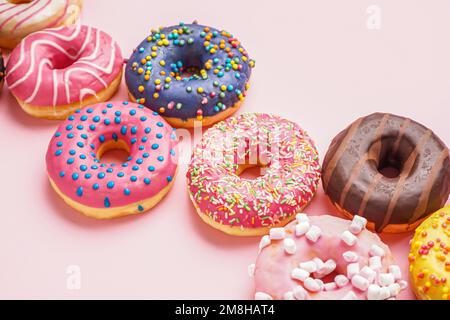 Tasty glazed donuts on pink background, closeup Stock Photo
