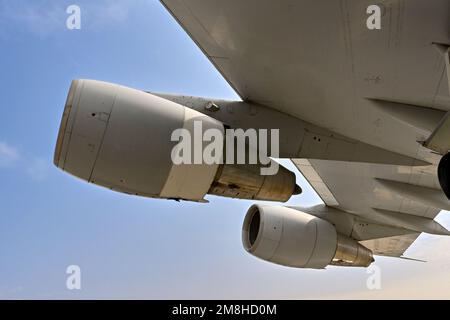 Engines of a large passenger jet in flight against a blue sky. No people.  Travel concept. Stock Photo