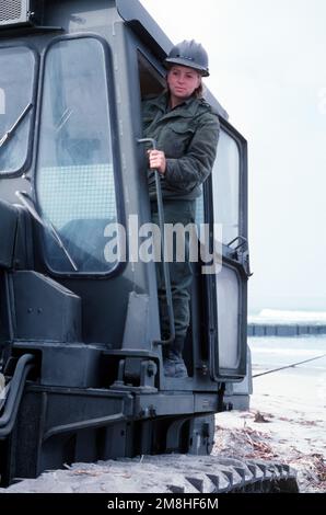 Equipment Operator Construction Apprentice Miller climbs operates a bulldozer during a causeway-building exercise with Amphibious Construction Battalion 1 (ACB-1). Base: Naval Amphibious Base, Coronado State: California (CA) Country: United States Of America (USA) Stock Photo