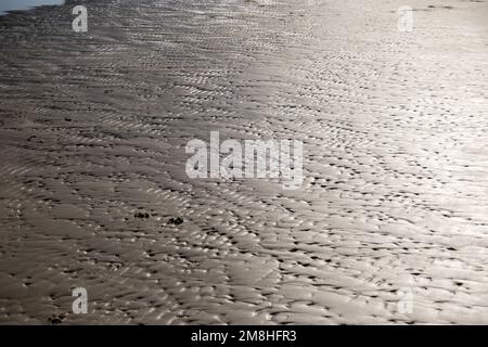 waves on the bright sand of a beach, at high noon Stock Photo