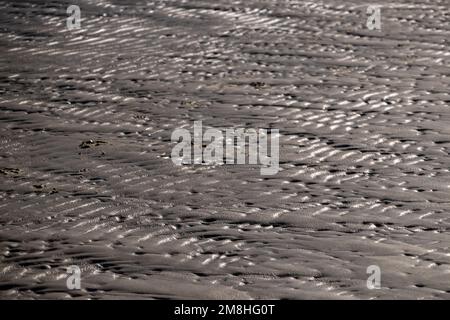 waves on the bright sand of a beach, at high noon Stock Photo