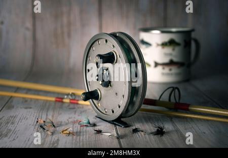 Vintage fly fishing reel and gear on rustic wooden background Stock Photo -  Alamy