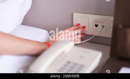 Closeup of woman hand is turned off on light switch in hotel Stock Photo