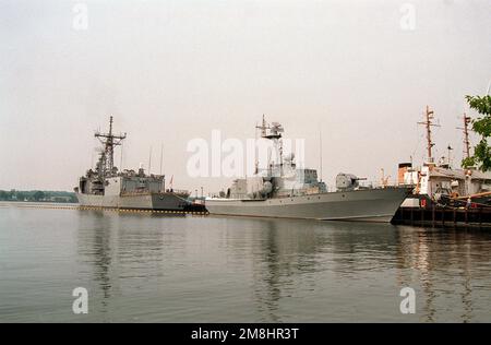 A starboard bow view of the USNS HIDDENSEE (185NS9201) moored at the Naval Sea Systems Command facility at Solomons Annex. The Soviet-built Tarantul I class missile corvette was acquired from the Federal German navy in November 1991, and is currently undergoing testing and evaluation by the U.S. Navy. The guided missile frigate USS OLIVER HAZARD PERRY (FFG-7) is moored behind HIDDENSEE and two Coast Guard buoy tender target hulks are in the background. Country: Solomons Stock Photo