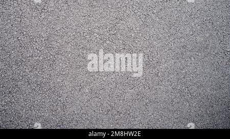 Rough texture of wall made of small gray cement pebbles Stock Photo