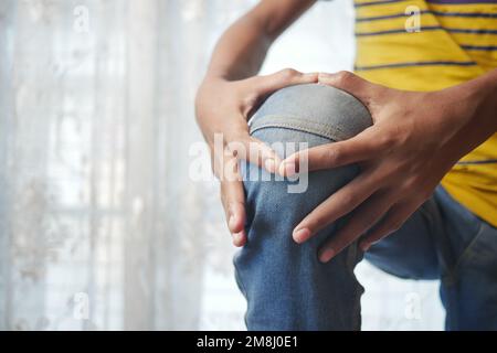 Close up on man suffering knee joint pain Stock Photo