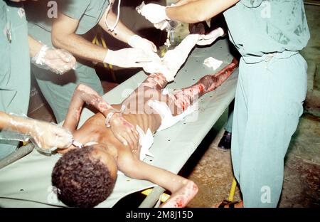 Dr. (LT. COL.) Bruderer, 46th Combat Support Hospital, performs a skin ...