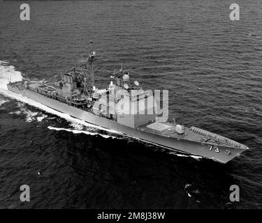 A high oblique port bow view of the guided missile cruiser USS PORT ...