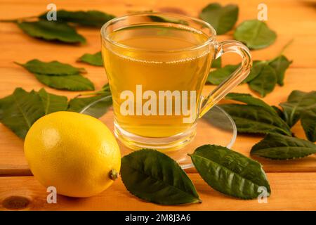 A cup of green tea, tea leaves and lemons,top view Stock Photo