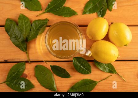 A cup of green tea, tea leaves and lemons,top view Stock Photo