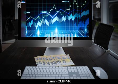 200 euro banknotes are lying next to a computer keyboard Stock Photo