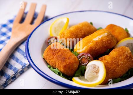 Fish croquette. The croquette is a portion of dough made from a dense sauce such as bechamel and a mincemeat of various ingredients or vegetables. Stock Photo