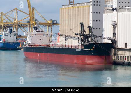 Bulk ship Thunder Island docked at the Contradique Quay next to the silo in the port of Barcelona on August 22, 2022. Stock Photo