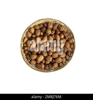 Dried nuts in wicker bowl isolated object top view, soft focus clipping path, pistachio, hazelnuts, walnuts, healthy raw food organic diet concept Stock Photo