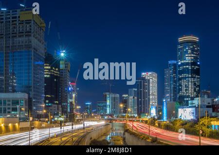 A long-exposure of traffic with light trails in the illuminated city Stock Photo