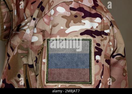 Russia Soldier. Soldier with flag Russia, Russia flag on a military uniform. Camouflage clothing Stock Photo