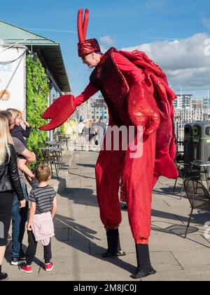 Stilt walker dressed as a lobster at Plymouth Seafood Festival 2022 Stock Photo