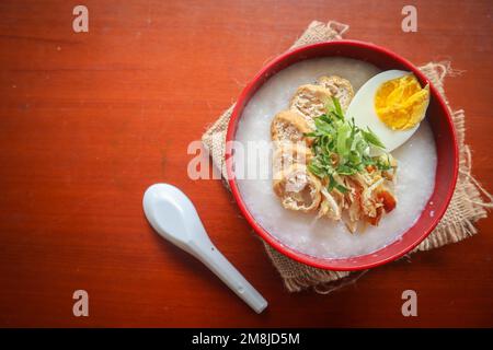 congee porridge with chicken slice, tofu, egg. congee porridge from hong kong. chinese food Stock Photo