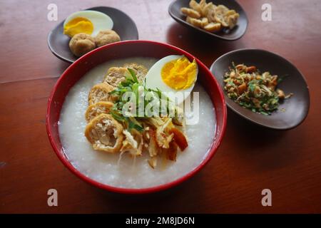 congee porridge with chicken slice, tofu, egg. congee porridge from hong kong. chinese food Stock Photo