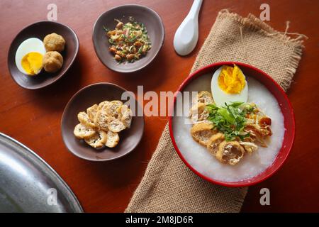 congee porridge with chicken slice, tofu, egg. congee porridge from hong kong. chinese food Stock Photo