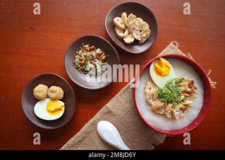 congee porridge with chicken slice, tofu, egg. congee porridge from hong kong. chinese food Stock Photo