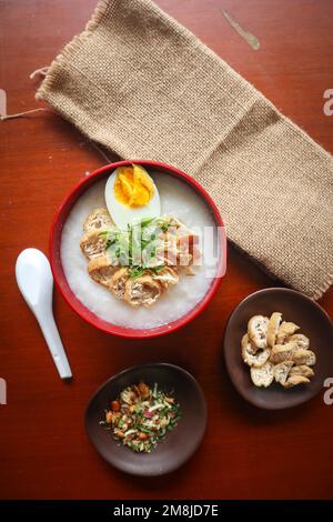 congee porridge with chicken slice, tofu, egg. congee porridge from hong kong. chinese food Stock Photo