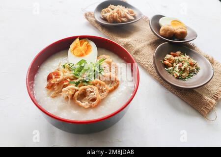 congee porridge with chicken slice, tofu, egg. congee porridge from hong kong. chinese food Stock Photo