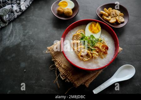 congee porridge with chicken slice, tofu, egg. congee porridge from hong kong. chinese food Stock Photo