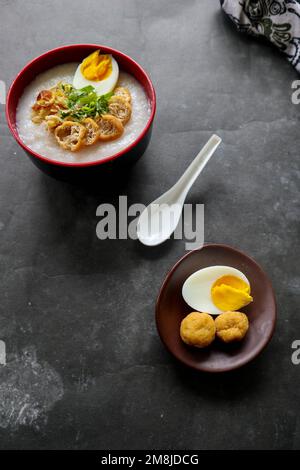 congee porridge with chicken slice, tofu, egg. congee porridge from hong kong. chinese food Stock Photo