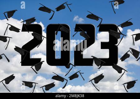 Black graduation caps airborne in the sky with black 2023 text Stock Photo