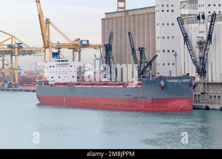 Bulk ship Nea Elpis docked at the Contradique Quay next to the silo in the port of Barcelona on December 13, 2022. Stock Photo