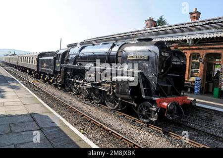 The British Railways built 92203 Black Prince 9F class locomotive pulls in at Toddington railway stations in the Cotswolds in Britain.  The Black Prin Stock Photo