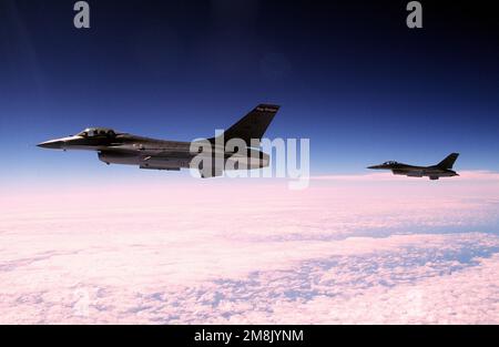 A left side view of two F-16 Fighting Falcons from the 119th Fighter Group, North Dakota Air National Guard, as they fly an air-to-air missile profile mission.(Exact date unknown). Subject Operation/Series: WILLIAM TELL '94 Base: Tyndall Air Force Base State: Florida (FL) Country: United States Of America (USA) Stock Photo
