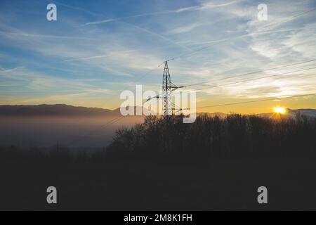 The communications tower with hills in the background at sunset Stock Photo