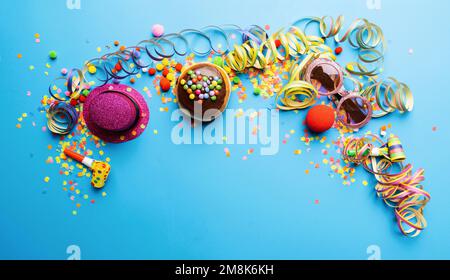 Krapfen, berliner or Carnival donut from Germany with icing sugar on a blue background, copy space with confetti and streamers on it - background for Stock Photo