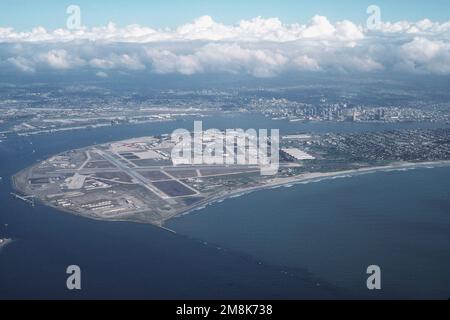 High oblique aerial view of the Naval Air Station North Island looking east towards the city of San Diego and Lindbergh Field (background). NAS San Diego is host to a vast naval industrial complex serving both naval surface and air force command, Pacific based squadrons, many major Pacific coast commands such as Commander, Naval Air Forces. Base: San Diego State: California (CA) Country: United States Of America (USA) Stock Photo