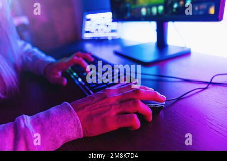 Professional guy typing on his keyboard and playing some game Stock Photo