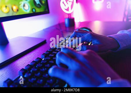 Professional cyber video gamer studio room with personal computer armchair, keyboard for stream in neon color blur background. Stock Photo