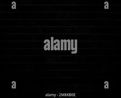 Front view of a dark and modern stone wall or building exterior. Dark, almost black, high resolution full frame textured background in black and white Stock Photo