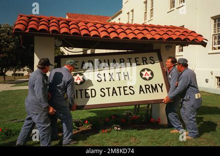 Workers removing the 6th US Army Headquarters Sign. Base: The Presidio, San Francisco State: California (CA) Country: United States Of America (USA) Stock Photo